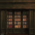 An elegant photography backdrop featuring dark wood-paneled bookshelves filled with antique, leather-bound books, creating a refined, vintage library setting.