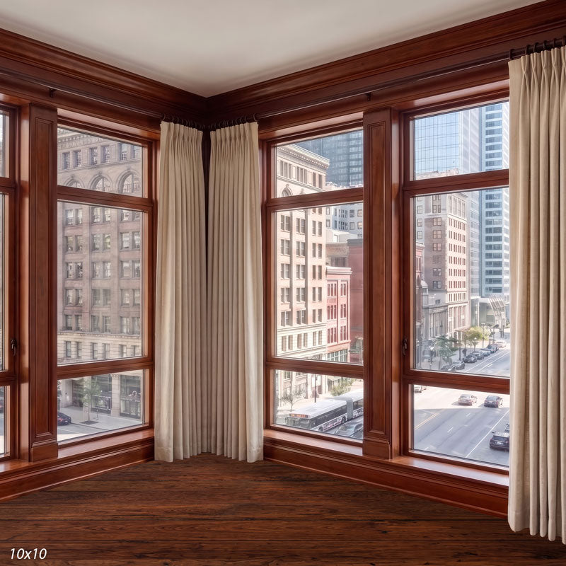 Wider view of the wood-framed office corner showing an additional window run and more of the historic downtown street below, a city view photography backdrop.