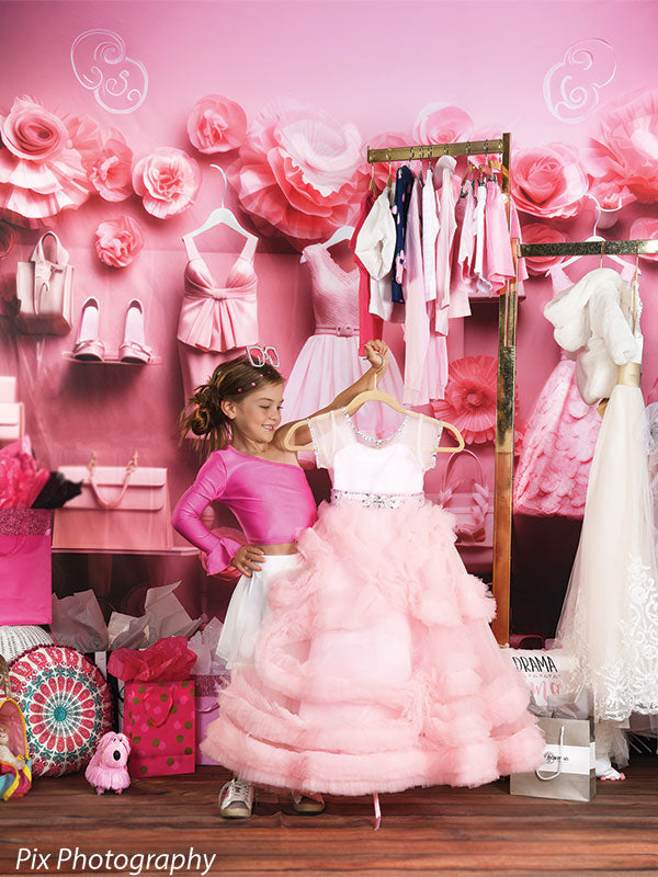 A stylish Barbie-inspired dream closet backdrop, featuring pink dresses, shoes, and glamorous décor, ideal for high-fashion photography sessions.
