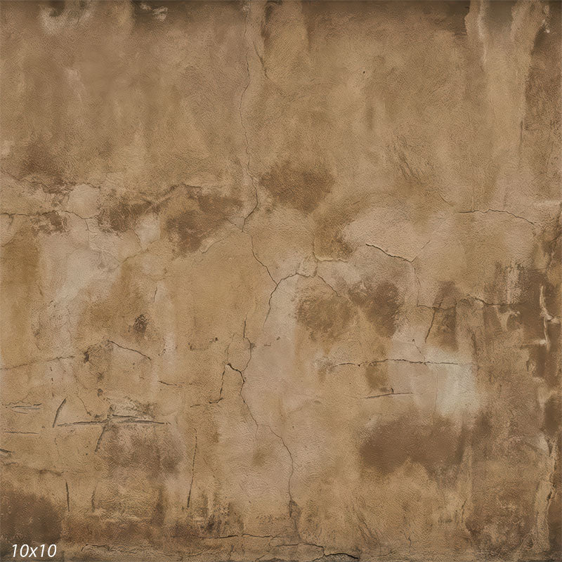 This studio background shows a continuous plaster wall surface with warm beige and brown tones, subtle cracking, and weathered texture suitable for portrait photography.