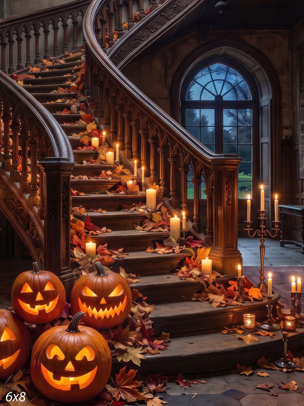 Ornate curved manor staircase dressed for Halloween with glowing jack-o'-lanterns, lit candles, and autumn leaves on the steps, a photography backdrop.
