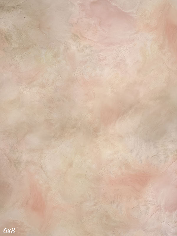 Printed photography backdrop showing soft blush and warm cream, a soft mottled painterly texture with gentle tonal movement.