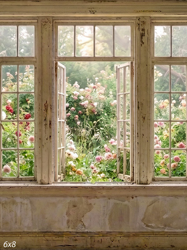 Rustic cottage interior with weathered white windows, one open, looking onto a blooming rose garden, a romantic photography backdrop.