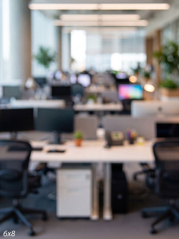 Bright modern open-plan office in soft focus with rows of white desks, black mesh chairs, and plants, a corporate photography backdrop.