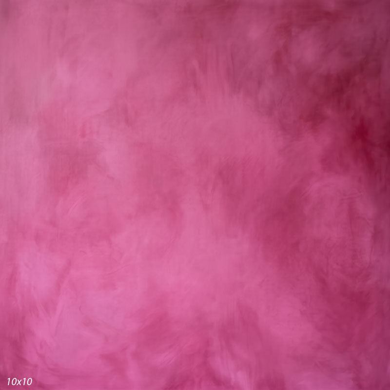 Printed studio background showing a painterly mottled vivid pink texture with a lighter center that deepens toward the edges.