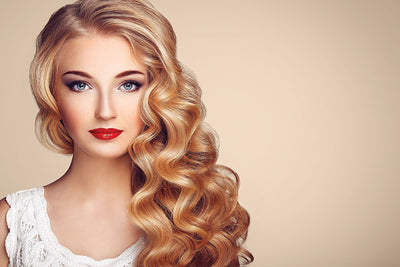 A fashion shoot setup using a buff seamless paper backdrop in a professional studio environment.