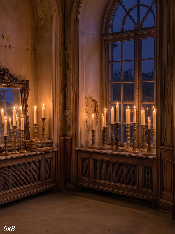 Faded room corner at dusk with tall arched windows and dozens of lit taper candles along wood cabinets and a gilt mirror, an antique interior photography backdrop.