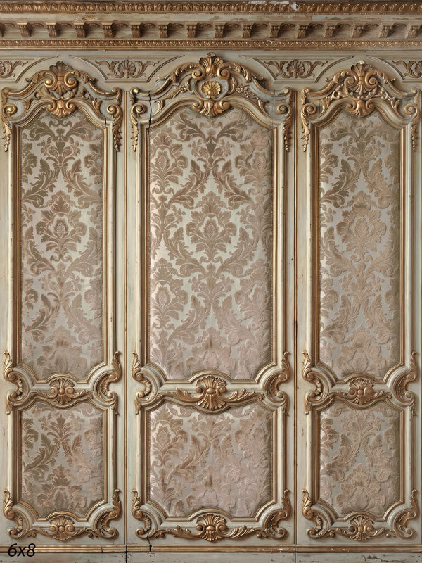 Ornate ivory-and-gold paneled wall with champagne damask brocade panels and carved rococo crests, a formal photography backdrop.