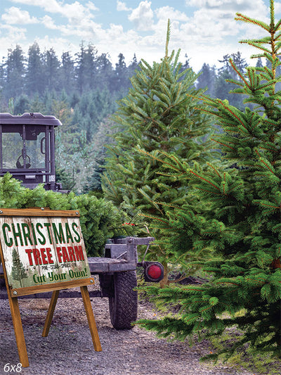 Christmas Tree Farm Backdrop - A festive Christmas tree farm scene featuring lush green pine trees, a vintage sign reading "Christmas Tree Farm - Pine, Cedar, Spruce - Cut Your Own!", and a tractor with a trailer loaded with freshly cut trees under a clear sky with fluffy white clouds.