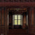 Classic dark wood panel photography backdrop featuring rich, intricately carved wood detailing, a grand window, and an elegant atmosphere for refined portraits and editorial shoots.