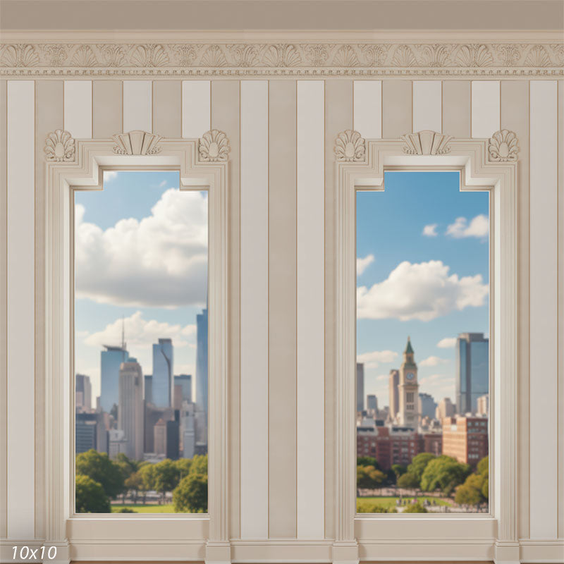 Wide view of an ivory paneled wall with two matching decorative windows, ornate frieze detail along the top, and a sunny city-park skyline visible through each opening.