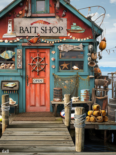 Coastal Bait Shop Photography Backdrop - A charming bait shop with weathered teal and red paint, adorned with nautical decorations like a ship’s wheel, seashells, starfish, and fishing nets. The dock in the foreground enhances the coastal charm, perfect for themed photoshoots.