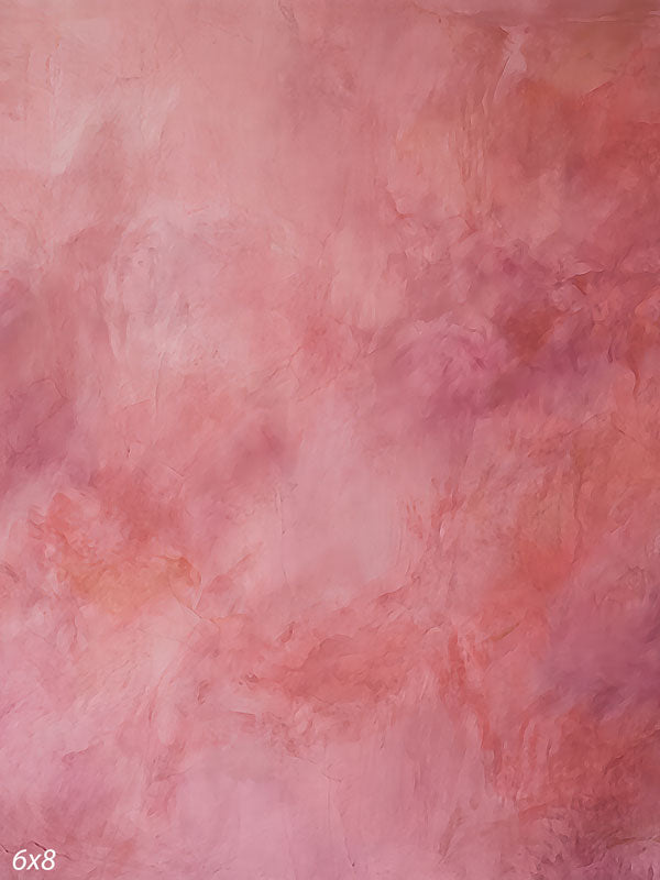 Printed photography backdrop showing warm coral and salmon pink, a soft mottled painterly texture with gentle tonal movement.