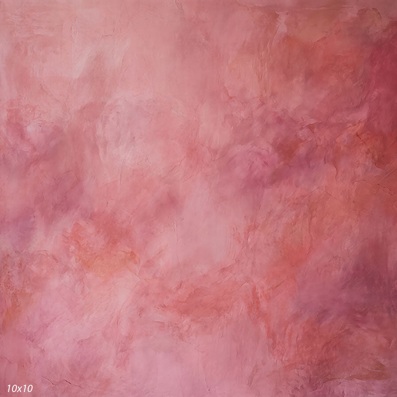 Printed studio background showing a painterly mottled coral pink texture with a lighter center that deepens toward the edges.