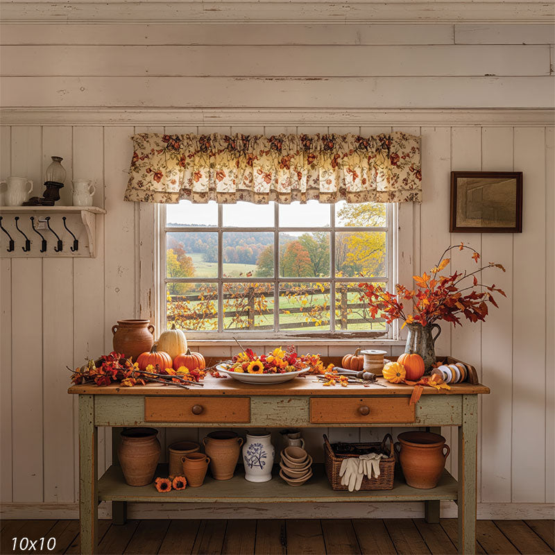 A rustic autumn window scene with a decorated farmhouse table and a view of rolling fields and colorful fall foliage.