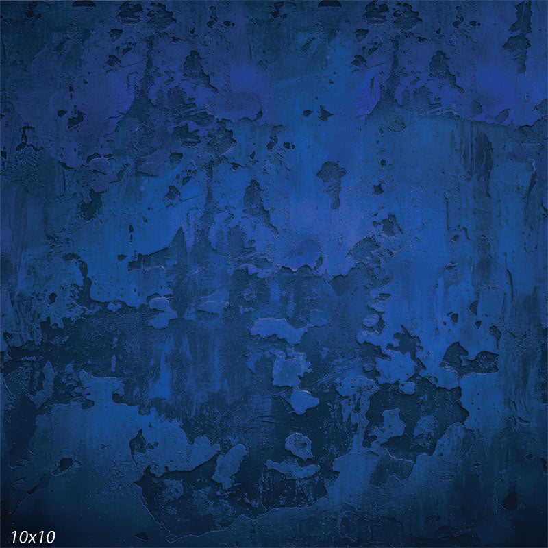 Printed studio background featuring layered deep blue tones with a weathered plaster look, scattered textured areas, and soft tonal variation. The pattern stays subtle behind a subject.
