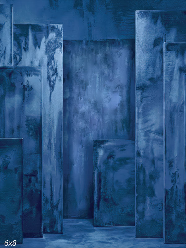 Deep blue photography backdrop showing layered rectangular panels with painterly plaster texture arranged in a dimensional studio environment.