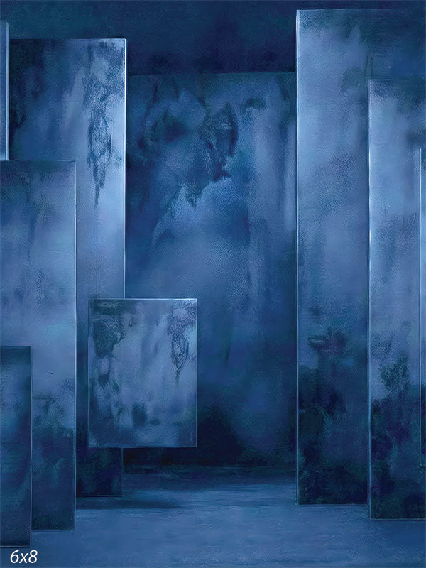 Deep blue photography backdrop featuring layered rectangular panels with painterly plaster-style texture arranged in a studio setting.