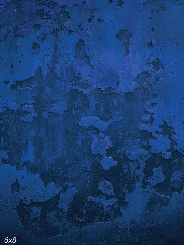 Printed photography backdrop showing a deep blue abstract plaster-style texture with distressed worn patches and subtle streaking. The surface reads as non-directional texture behind a subject.