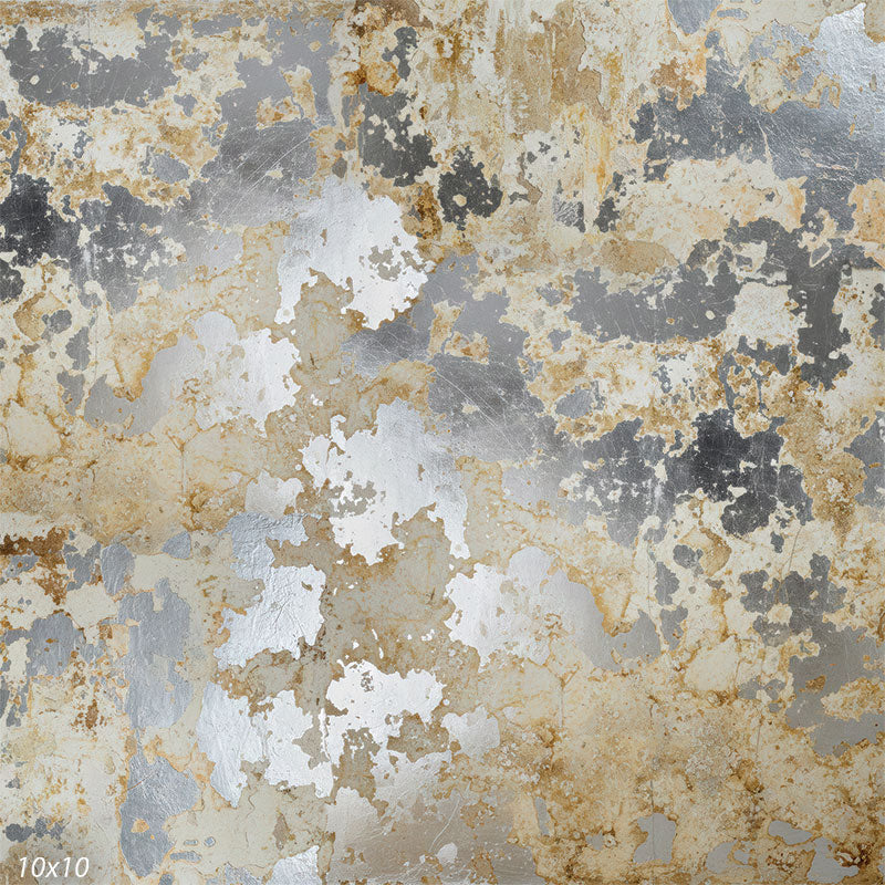 Printed studio background featuring layered metallic silver areas, soft beige and ivory tones, and scattered gray distressed patches across the surface. The abstract texture provides a neutral backdrop behind a subject.