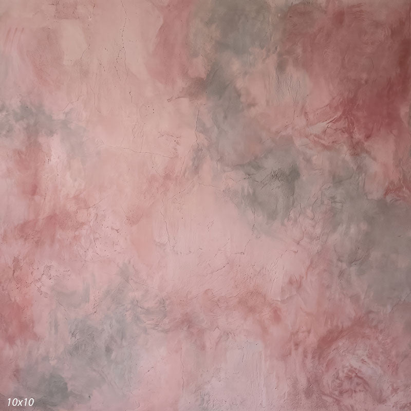 Printed studio background showing a painterly mottled dusty rose texture with a lighter center that deepens toward the edges.