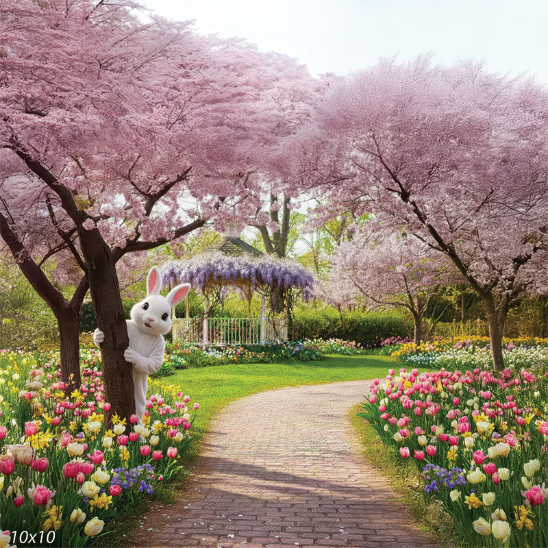 A photography backdrop featuring a costumed Easter Bunny hiding behind a tree in a flower garden. A brick path leads toward a gazebo.