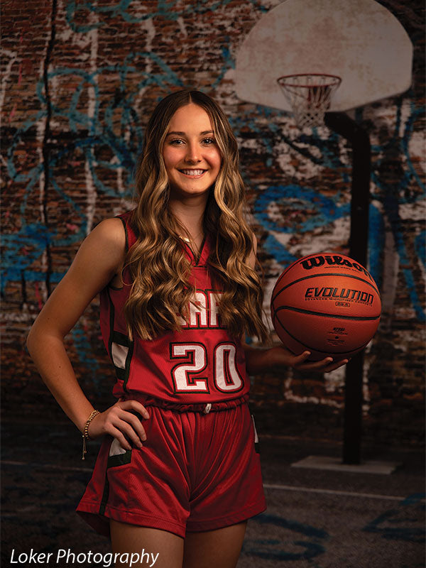 Edgy basketball court backdrop featuring street art and a weathered hoop, perfect for sports editorials and high-impact photography.