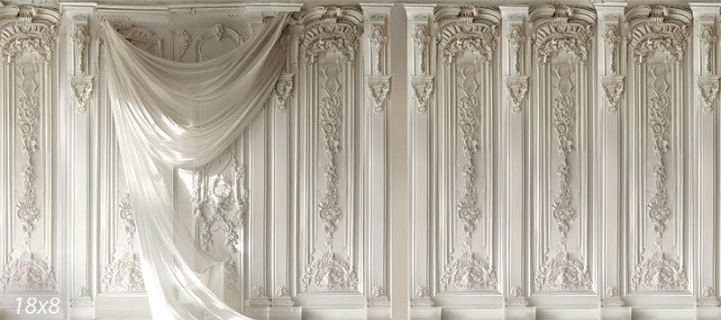 Elegant Ornate Classical Panel Wall Photography Backdrop - Elegant white backdrop featuring tall, intricately carved panels with classical floral patterns, adorned with a sheer white drape cascading across from left to right.