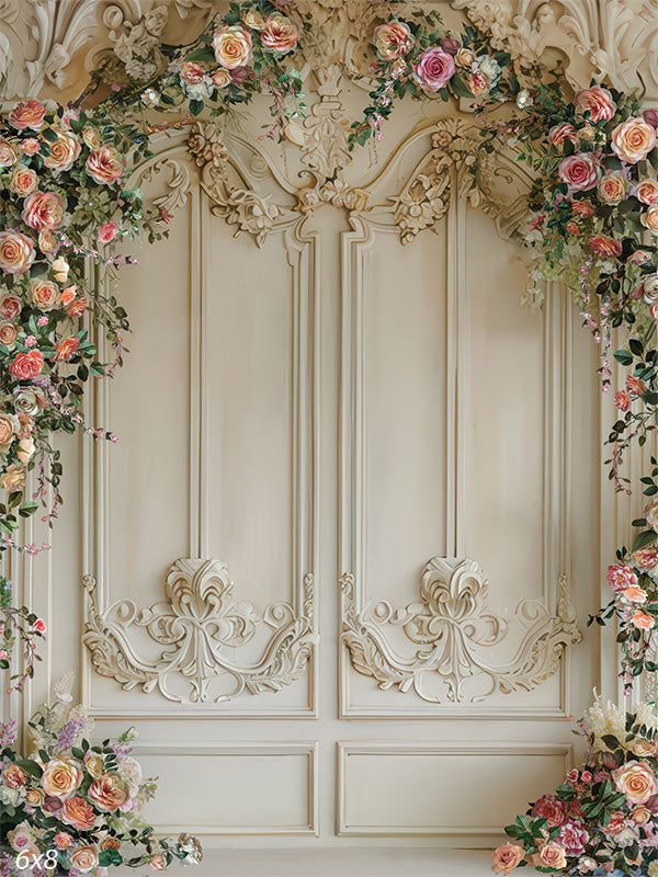Elegant floral backdrop featuring ornate cream wall details and cascading spring flowers for photography sessions.