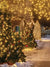 Enchanted Winter Night Christmas Photography Backdrop - Magical winter night scene with snow-covered Christmas trees adorned with ornaments and glowing fairy lights, a street illuminated with warm, golden lights, and quaint wooden houses decorated for the holidays.