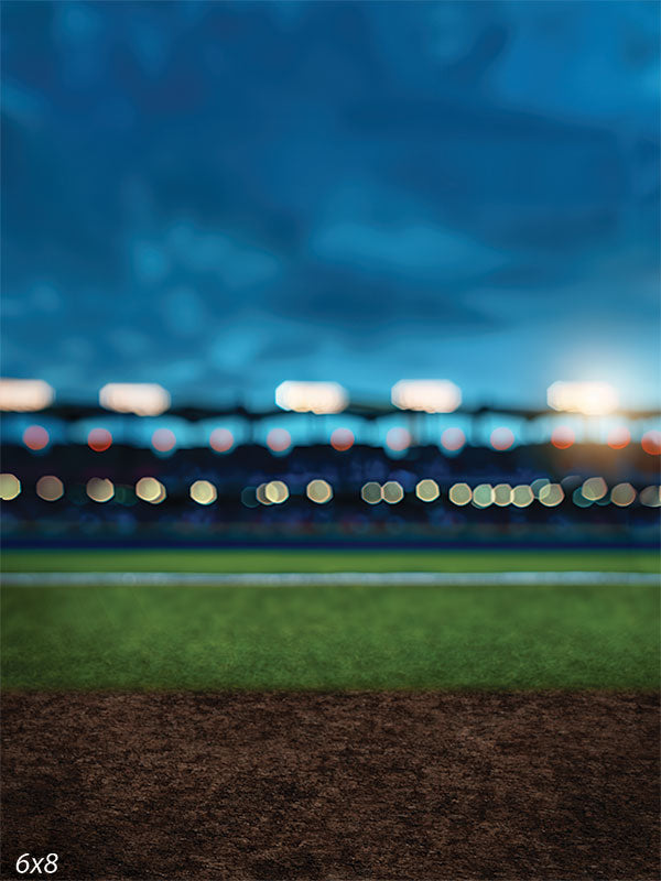 Sports stadium backdrop featuring an evening sky, green field, and bokeh stadium lights for professional sports photography sessions.