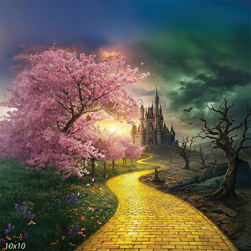 Square-format photography backdrop featuring a yellow brick path, pink cherry blossoms, wildflowers, a distant castle, and contrasting barren terrain beneath shifting clouds.