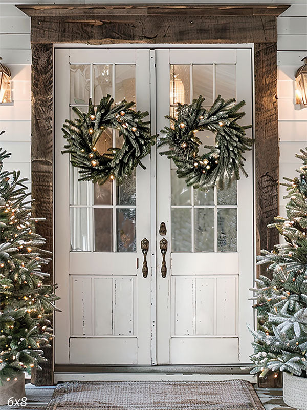 Farmhouse Christmas photography backdrop featuring white double doors with lit evergreen wreaths, rustic wood framing, and snow-dusted Christmas trees—perfect for clean, cozy holiday portraits and winter studio sessions.