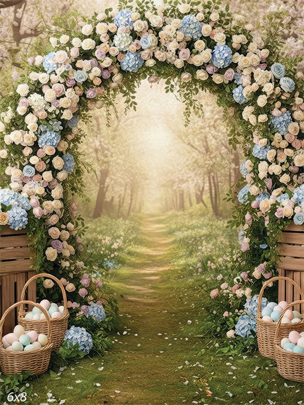 A studio background showing a large floral arch made of roses and hydrangeas. Wooden crates and baskets of eggs sit at the base of a forest path.