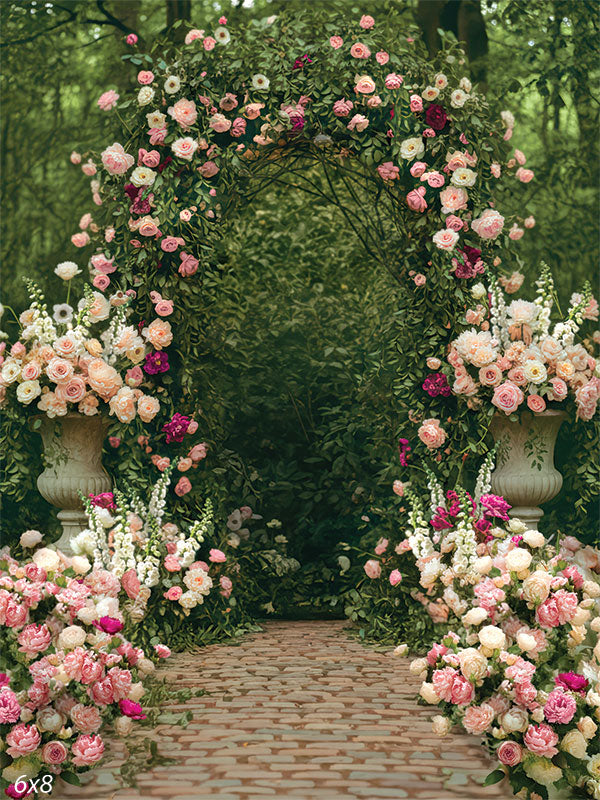 Romantic garden backdrop featuring a floral arch with lush blush and ivory blooms, perfect for weddings and styled portraits.