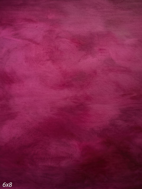 Printed photography backdrop showing rich fuchsia and berry magenta, a soft mottled painterly texture with gentle tonal movement.