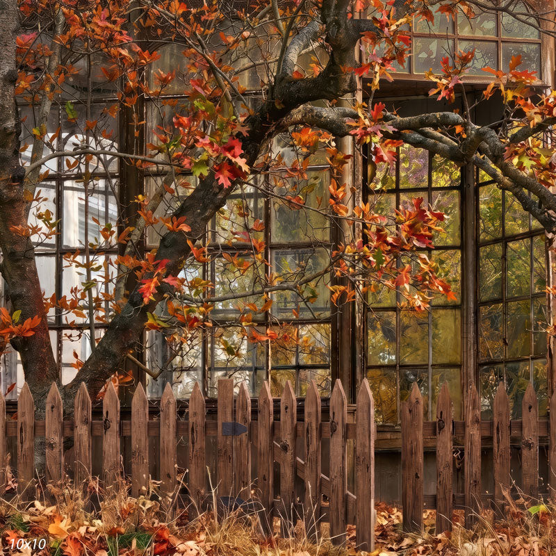 Rustic greenhouse photography backdrop shown wider, with the full window wall, picket fence, and drifts of fallen autumn leaves along the ground.