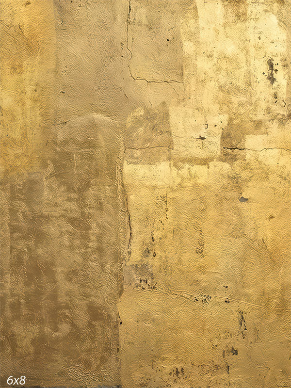 A photography backdrop showing a gold-toned plaster wall with layered texture, subtle cracking, and warm ochre color variation for studio portraits.