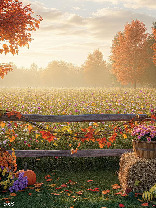 A scenic photography backdrop featuring a wildflower-filled meadow, rustic fence, pumpkins, and vibrant autumn foliage.