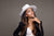 A portrait session featuring a subject against a gray medium seamless backdrop, ideal for editorial and commercial photography.