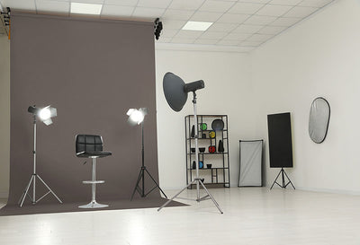 A gray medium seamless photography backdrop in a professional studio setting, perfect for fashion, portraits, and commercial shoots.