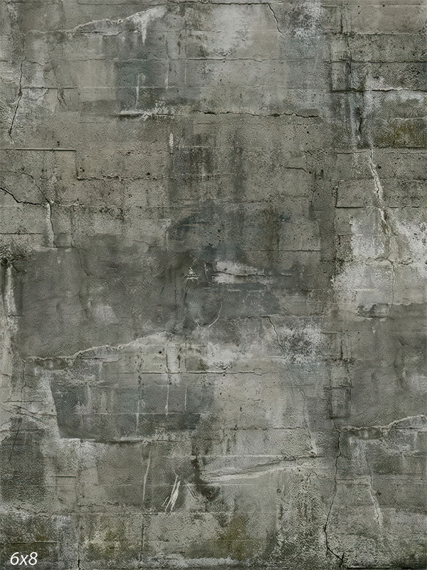 A photography backdrop showing a weathered concrete wall with layered gray tones, fine cracks, softened block texture, and a matte surface.