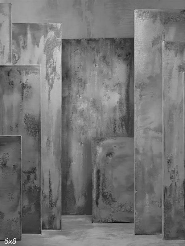 Gray photography backdrop showing layered rectangular panels with plaster-style texture arranged in a dimensional studio setting.