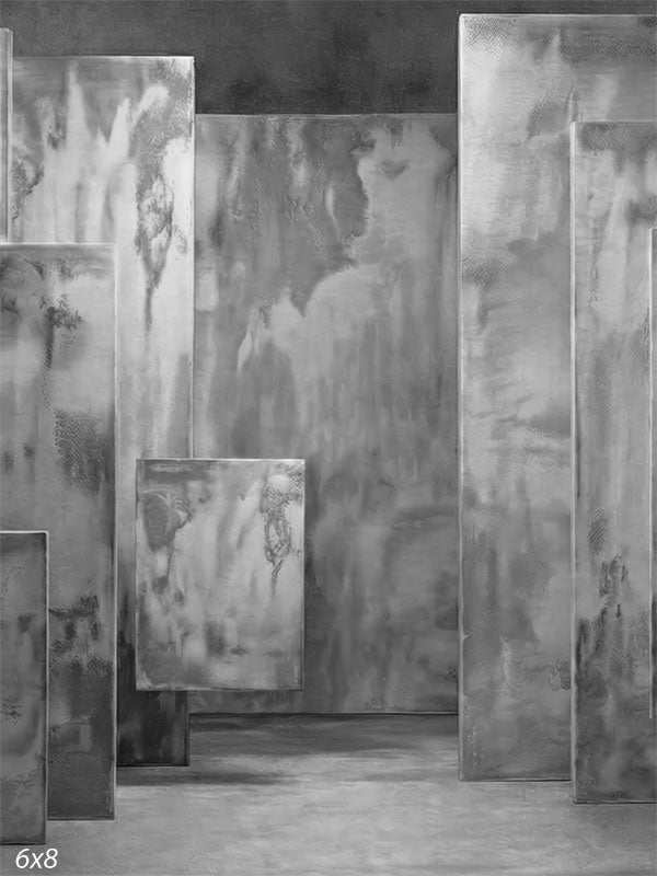 Gray photography backdrop showing layered rectangular panels with plaster-style texture arranged in a dimensional studio setting.