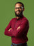 A headshot photography session utilizing a green screen seamless backdrop for digital background replacement.
