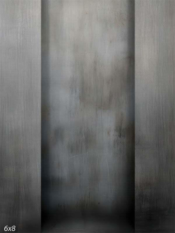 A studio background featuring three vertical panels resembling brushed steel or concrete. The center is lighter while the sides are darker grey with vertical streaks.