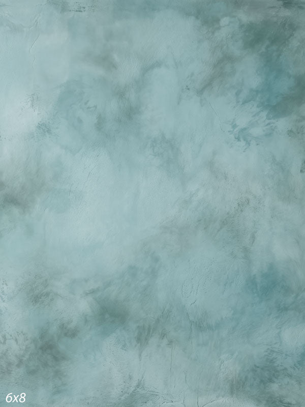 Printed photography backdrop showing pale slate blue-gray, a soft mottled painterly texture with gentle tonal movement.