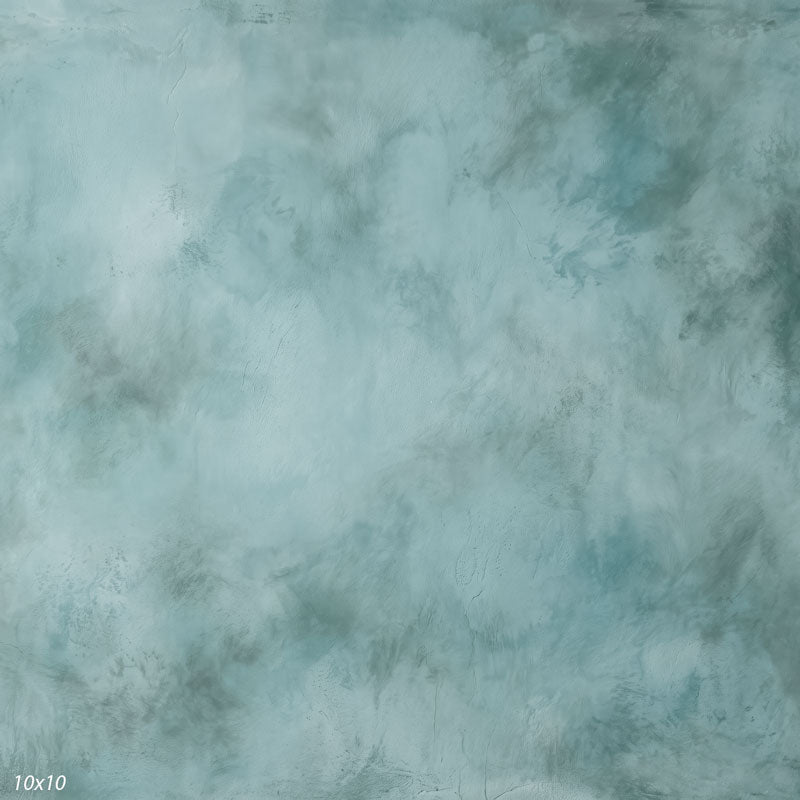 Printed studio background showing a painterly mottled pale slate blue texture with a lighter center that deepens toward the edges.