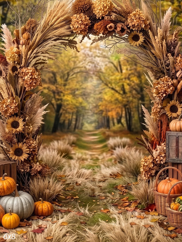 Autumn harvest photography backdrop with a dried-flower and sunflower arch framing a soft forest path, pumpkins, gourds, and baskets at the base.