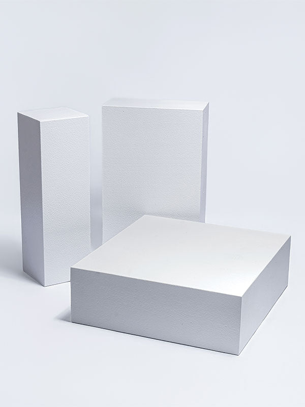 The three individual white foam posing steps shown separately — one standing upright, one on its face, and one flat — as a studio photography posing prop set.
